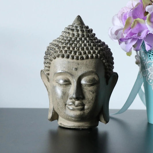 statue tete bouddha face fleurs